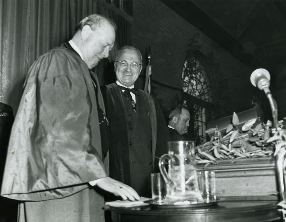 Churchill and Truman stand together on stage